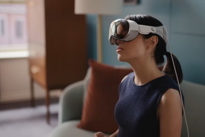 A woman using Apple Vision Pro at home